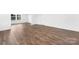 Large bedroom with wood-look flooring and many windows at 12437 Walker Dr # 89, Stanfield, NC 28163