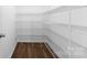 Spacious walk-in closet with shelving and wood-look flooring at 12437 Walker Dr # 89, Stanfield, NC 28163