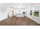 Modern kitchen with white cabinets, a center island, stainless steel appliances, and hardwood floors throughout at 12437 Walker Dr # 89, Stanfield, NC 28163