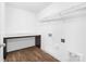 Functional laundry room with counter space, shelving, and wood-look floors at 12437 Walker Dr # 89, Stanfield, NC 28163