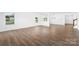 Open living space featuring hardwood floors, large windows providing natural light, and neutral wall paint at 12437 Walker Dr # 89, Stanfield, NC 28163