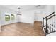 Bright living space with hardwood floors, large windows, and a staircase leading to the upper level at 12437 Walker Dr # 89, Stanfield, NC 28163