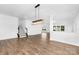 Open living space featuring hardwood floors, recessed lighting, and a staircase leading to the upper level at 12437 Walker Dr # 89, Stanfield, NC 28163