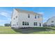 The back of this house features a well-manicured lawn, multiple windows, and light gray siding at 12437 Walker Dr # 89, Stanfield, NC 28163