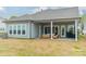 Backyard featuring a covered patio with stylish furniture and a lush green lawn at 1402 Encore Ln, Waxhaw, NC 28173