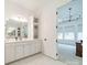 Bathroom featuring double sinks, white cabinets, and an entryway into the main bedroom at 1402 Encore Ln, Waxhaw, NC 28173