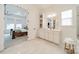 Bathroom showcasing double sinks, white cabinets, and an entryway into the main bedroom at 1402 Encore Ln, Waxhaw, NC 28173