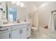 Well-lit bathroom with white cabinets, modern fixtures, and a tub/shower combo at 1402 Encore Ln, Waxhaw, NC 28173