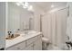 Well-lit bathroom featuring a modern vanity with mirror and a shower with white curtain at 1402 Encore Ln, Waxhaw, NC 28173