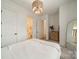 Bright bedroom featuring a neutral color palette, stylish light fixture, and attached bathroom at 1402 Encore Ln, Waxhaw, NC 28173