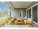 Inviting covered patio with stylish outdoor furniture and a neutral color palette at 1402 Encore Ln, Waxhaw, NC 28173