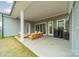 Inviting covered patio with stylish outdoor furniture and a barbecue grill at 1402 Encore Ln, Waxhaw, NC 28173