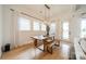 Well-lit dining room with a modern light fixture, white walls, and hardwood floors at 1402 Encore Ln, Waxhaw, NC 28173