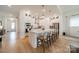 Beautiful kitchen features an island with seating, stainless appliances, custom cabinetry, and hardwood floors at 1402 Encore Ln, Waxhaw, NC 28173
