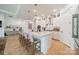 Elegant kitchen featuring an island with bar seating, stainless appliances, custom cabinetry, and hardwood floors at 1402 Encore Ln, Waxhaw, NC 28173
