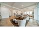 Spacious, open-concept living room connecting the kitchen, dining area, and living area featuring light-colored hardwood flooring at 1402 Encore Ln, Waxhaw, NC 28173
