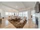 Spacious and bright living room featuring hardwood floors, a large area rug, and plenty of natural light at 1402 Encore Ln, Waxhaw, NC 28173