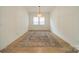 Living room showcasing the expansive hardwood floors and a modern light fixture at 1402 Encore Ln, Waxhaw, NC 28173