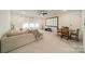 Living room featuring ample windows, ceiling fan, projector screen, and seating area at 1402 Encore Ln, Waxhaw, NC 28173