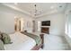 Airy main bedroom offering natural light, a tray ceiling, carpeted floors, and easy access to the ensuite bathroom at 1402 Encore Ln, Waxhaw, NC 28173