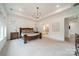 Bright main bedroom featuring a tray ceiling, carpet flooring, and ample natural light at 1402 Encore Ln, Waxhaw, NC 28173