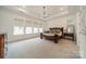 Spacious main bedroom with tray ceiling, large windows, and carpeted flooring at 1402 Encore Ln, Waxhaw, NC 28173