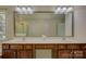 Bathroom featuring a double vanity, large mirror, and wood cabinets at 14103 Grand Traverse Dr, Charlotte, NC 28278