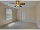 Neutral bedroom featuring a ceiling fan and a window offering natural light at 14103 Grand Traverse Dr, Charlotte, NC 28278