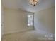 Bright bedroom with neutral walls, carpet, a window, and modern ceiling light at 14103 Grand Traverse Dr, Charlotte, NC 28278
