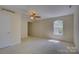 Well-lit bedroom featuring neutral walls and carpet with large windows and ceiling fan at 14103 Grand Traverse Dr, Charlotte, NC 28278