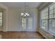 Features an open dining room with hardwood floors, natural lighting, and a chandelier at 14103 Grand Traverse Dr, Charlotte, NC 28278