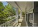 Inviting front porch with white railing and columns, providing a relaxing outdoor space at 14103 Grand Traverse Dr, Charlotte, NC 28278