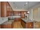 Features a spacious kitchen with stainless steel appliances, granite countertops, and wooden cabinetry at 14103 Grand Traverse Dr, Charlotte, NC 28278