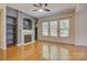 Cozy living room featuring a fireplace, built-in shelving, and large windows at 14103 Grand Traverse Dr, Charlotte, NC 28278