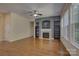 Bright living room featuring hardwood floors, a fireplace with shelving, and large windows at 14103 Grand Traverse Dr, Charlotte, NC 28278