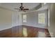 Spacious main bedroom with wooden floors, ceiling fan, tray ceiling and double windows at 14103 Grand Traverse Dr, Charlotte, NC 28278