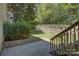 Stone patio featuring stairs and retaining wall with beautiful yard and foliage at 14103 Grand Traverse Dr, Charlotte, NC 28278