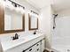 Bathroom featuring double sink vanity with wood framed mirrors and a walk in shower at 1451 Cherryville Rd, Shelby, NC 28150