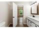 Bright bathroom features a modern vanity, stylish fixtures, and an open doorway to the bedroom at 1451 Cherryville Rd, Shelby, NC 28150