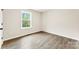 Clean, minimalist bedroom with natural light, wood-look flooring and neutral paint at 1451 Cherryville Rd, Shelby, NC 28150