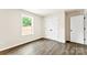 Bedroom featuring wood-look floors, window with view, and white closet doors with black hardware at 1451 Cherryville Rd, Shelby, NC 28150