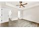 Bedroom featuring wood-look floors, neutral walls, ceiling fan and view to the bathroom at 1451 Cherryville Rd, Shelby, NC 28150