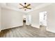 Bedroom featuring wood-look floors, neutral walls, ceiling fan and view to the bathroom and kitchen at 1451 Cherryville Rd, Shelby, NC 28150