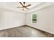 Bedroom featuring wood-look floors, neutral walls, and a window showcasing the outdoor greenery at 1451 Cherryville Rd, Shelby, NC 28150