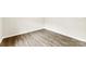 Empty bedroom space with wood-look flooring, light-colored walls, and base-molding at 1451 Cherryville Rd, Shelby, NC 28150