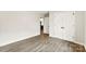 Bedroom with wood-look flooring, large closet, and a view into the home at 1451 Cherryville Rd, Shelby, NC 28150
