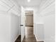 Spacious closet with rod iron shelving leads to bedroom, offering ample storage with wood-look flooring at 1451 Cherryville Rd, Shelby, NC 28150