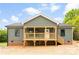 New construction home with green siding and a welcoming wooden porch with access stairs at 1451 Cherryville Rd, Shelby, NC 28150