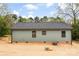 Rear exterior view of home with green vinyl siding and a compact backyard at 1451 Cherryville Rd, Shelby, NC 28150
