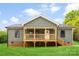 Charming home showcasing a wooden porch, green vinyl siding, and brick foundation accents at 1451 Cherryville Rd, Shelby, NC 28150